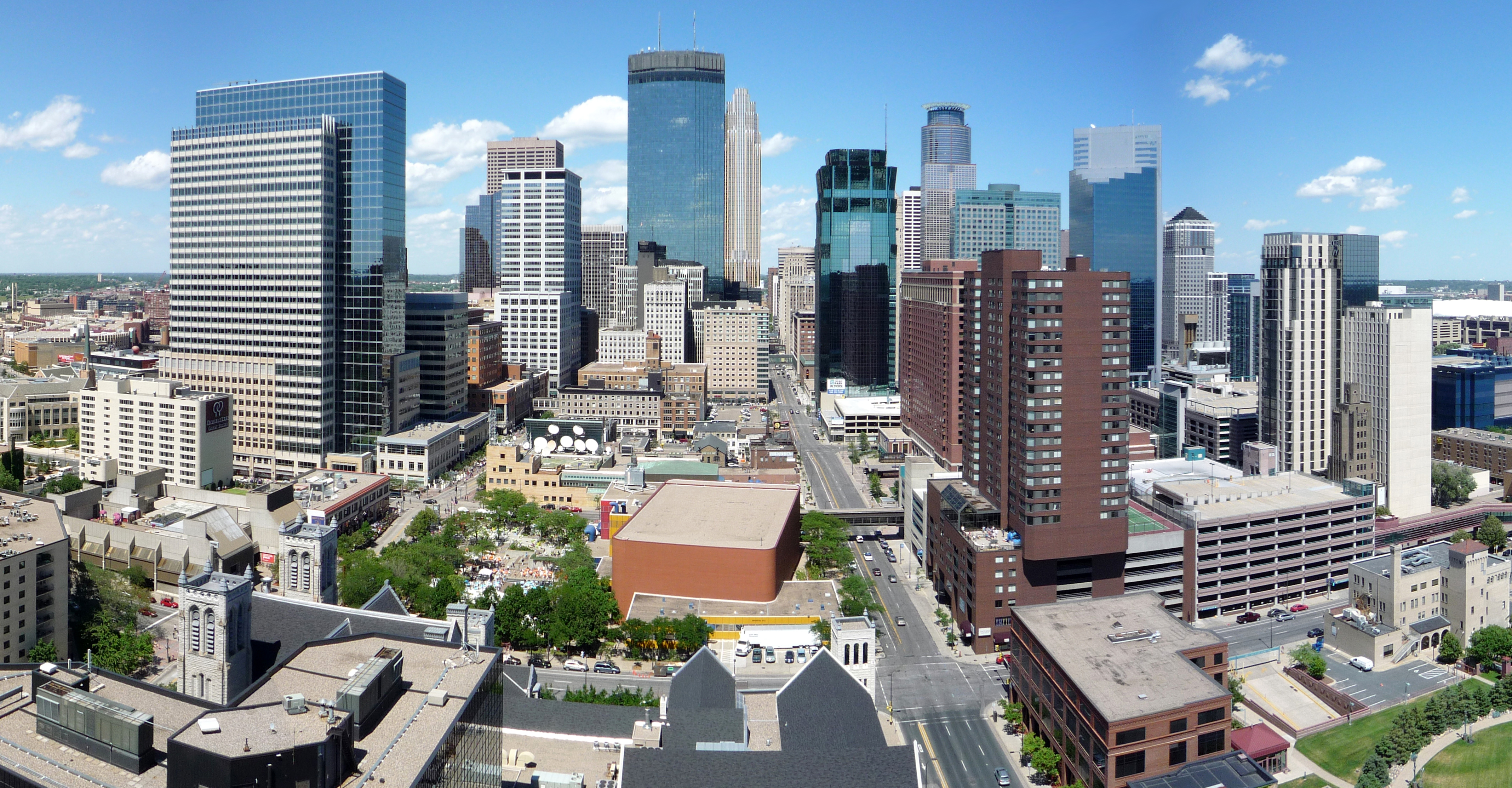 Minneapolis–Saint Paul is a metropolitan area in the Upper Midwestern United States centered around the confluence of the Mississippi, Minnesota and St. Croix rivers in the U.S. state of Minnesota. It is commonly known as the Twin Cities after the area's two largest cities, Minneapolis and Saint Paul. Minnesotans often refer to the two together (or the seven-county metro area collectively) simply as "the cities". The area is Minnesota's economic, cultural, and political center.
Minneapolis and Saint Paul are independent municipalities with defined borders. Minneapolis sits mostly on the west side of the Mississippi River on lake-covered terrain. Although most of the city is residential neighborhoods, it has a business-dominated downtown area with some historic industrial areas, the Mill District and the North Loop area. Saint Paul, which sits mostly on the east side of the river, has a smaller business district, many tree-lined neighborhoods, and a large collection of late-Victorian architecture. Both cities, and the surrounding smaller cities, feature lakes, hills, and creeks.
Originally inhabited by the Ojibwe and Dakota people, the cities were settled by various Europeans. Minneapolis was strongly influenced by early Scandinavian and Lutheran settlers, while Saint Paul was settled predominantly by the French, the Irish, and German Catholics. Both urban areas are home to new immigrant communities, including Mexicans, Somalis, Hmong, Indians, Oromo, Vietnamese, Cameroonians, and Liberians.
"Twin Cities" is sometimes used to refer to the seven-county region governed by the Metropolitan Council regional governmental agency and planning organization. The United States Office of Management and Budget officially designates 15 counties as the "Minneapolis–St. Paul–Bloomington MN–WI Metropolitan Statistical Area". It is the 16th-largest metropolitan statistical area and third-largest metropolitan area in the Midwest, with a population of 3,690,261 at the 2020 census. The larger 21-county Minneapolis–St. Paul MN–WI Combined Statistical Area, the nation's 16th-largest combined statistical area, had a population of 4,078,788 at the 2020 census.