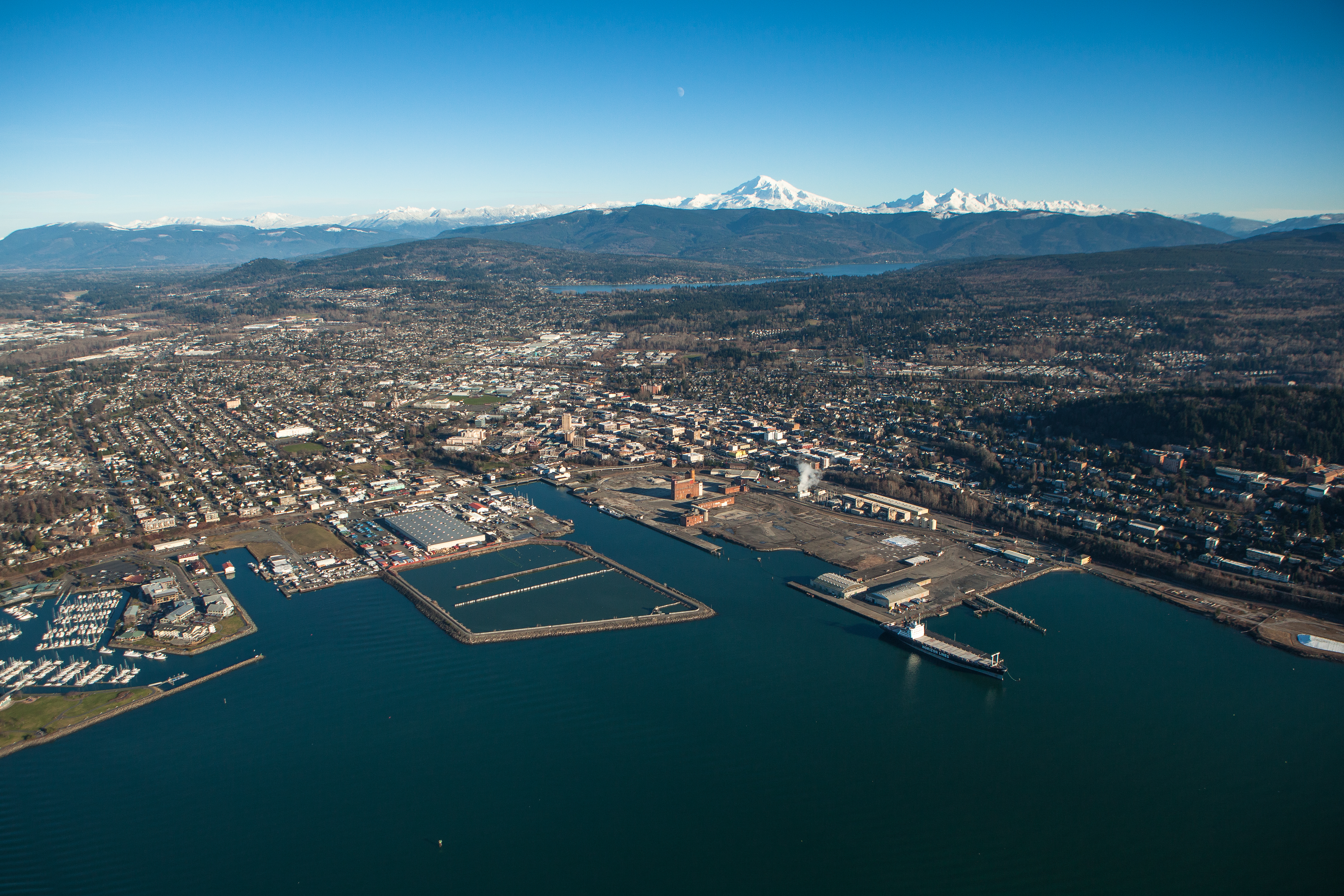 Bellingham ( BEL-ing-ham) is the most populous city in, and county seat of Whatcom County in the U.S. state of Washington. It lies 21 miles (34 km) south of the U.S.–Canada border and in between Vancouver, British Columbia (located 52 miles (84 km) to the northwest) and Seattle (90 miles (140 km) to the south). 
The city had a population of 91,482 as of the 2020 census. It is the site of Western Washington University, Bellingham International Airport, and is the southern terminus of the Alaska Marine Highway system. Bellingham is the northernmost city with a population of more than 90,000 people in the contiguous United States.The area around Bellingham Bay, named in 1792 by George Vancouver, is the ancestral home of several Coast Salish groups. European settlement in modern-day Bellingham began in the 1850s and several coal mining towns grew in later years. The city of Bellingham was incorporated in 1903 through the consolidation of several settlements, among them Fairhaven. Local industries shifted away from coal in the mid-20th century; the industrial areas of the Bellingham waterfront have undergone redevelopment into a mixed-use neighborhood since the 2000s.
