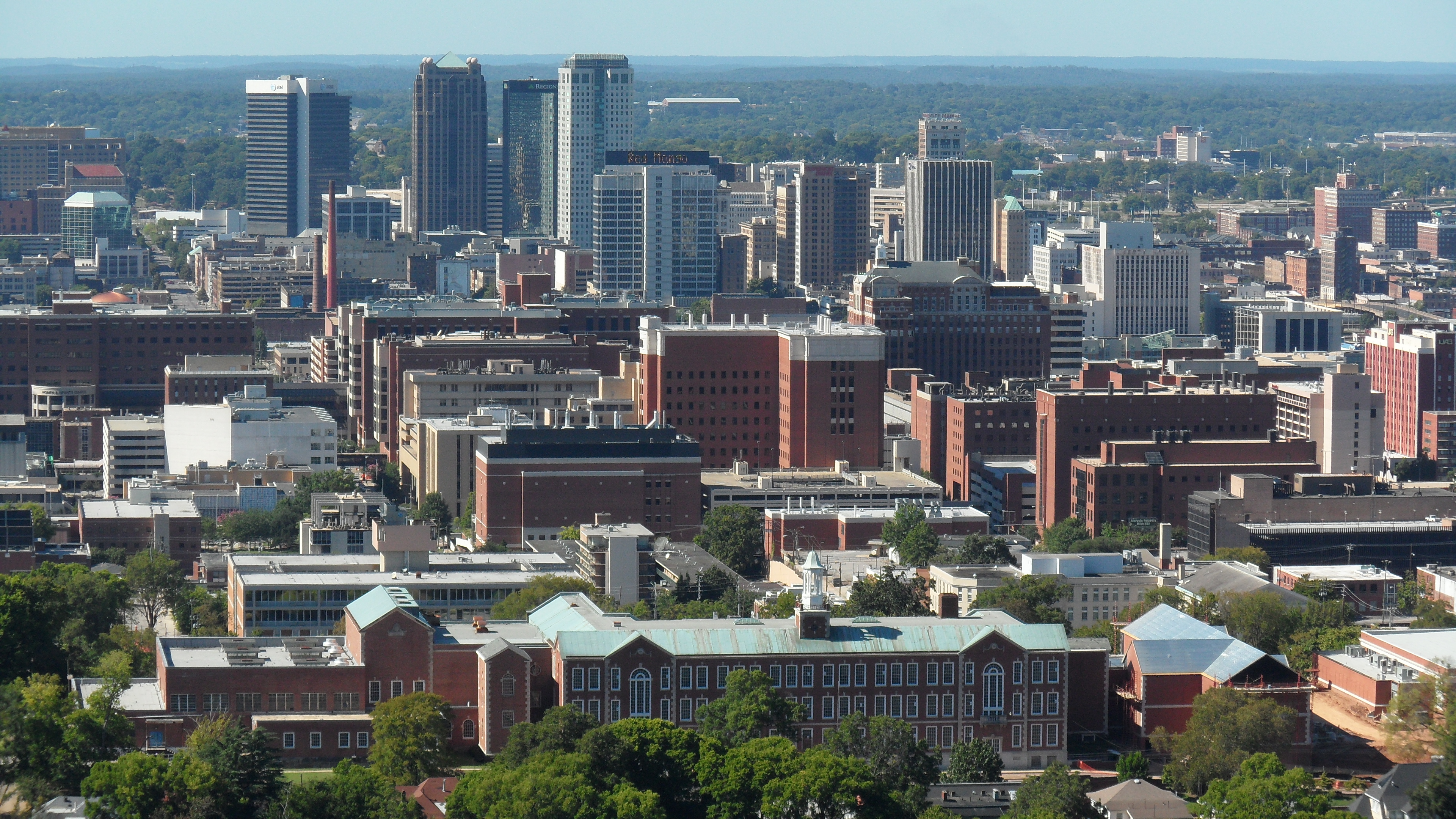 Birmingham ( BUR-ming-ham) is a city in the north central region of the U.S. state of Alabama. Birmingham is the seat of Jefferson County, Alabama's most populous county. As of the 2022 census estimates, Birmingham had a population of 196,910, down 2% from the 2020 census, making it Alabama's third-most populous city after Huntsville and Montgomery. The broader Birmingham metropolitan area had a 2020 population of 1,115,289, and is the largest metropolitan area in Alabama as well as the 50th-most populous in the United States. Birmingham serves as an important regional hub and is associated with the Deep South, Piedmont, and Appalachian regions of the nation.
Birmingham was founded in 1871, during the post–Civil War Reconstruction period, through the merger of three pre-existing farm towns, notably, Elyton. It grew from there, annexing many more of its smaller neighbors, into an industrial and railroad transportation center with a focus on mining, the iron and steel industry, and railroading. Birmingham was named after Birmingham, England, one of the UK's major industrial cities. Most of the original settlers who founded Birmingham were of English ancestry. The city may have been planned as a place where cheap, non-unionized, and often African-American labor from rural Alabama could be employed in the city's steel mills and blast furnaces, giving it a competitive advantage over industrial cities in the Midwest and Northeast.From its founding through the end of the 1960s, Birmingham was a primary industrial center of the South. The pace of Birmingham's growth during the period from 1881 through 1920 earned its nicknames The Magic City and The Pittsburgh of the South. Much like Pittsburgh, Birmingham's major industries were iron and steel production, plus a major component of the railroading industry, where rails and railroad cars were both manufactured in Birmingham. In the field of railroading, the two primary hubs of railroading in the Deep South were nearby Atlanta and Birmingham, beginning in the 1860s and continuing through to the present day. The economy diversified during the later half of the twentieth century. Though the manufacturing industry maintains a strong presence in Birmingham, other businesses and industries such as banking, telecommunications, transportation, electrical power transmission, medical care, college education, and insurance have risen in stature. Mining in the Birmingham area is no longer a major industry with the exception of coal mining. Birmingham ranks as one of the most important business centers in the Southeastern United States and is also one of the largest banking centers in the United States. In addition, the Birmingham area serves as headquarters to one Fortune 500 company: Regions Financial, along with five other Fortune 1000 companies.
In higher education, Birmingham has been the location of the University of Alabama at Birmingham School of Medicine (formerly the Medical College of Alabama) and the University of Alabama at Birmingham School of Dentistry since 1947. In 1969 the University of Alabama at Birmingham was established, one of three main campuses of the University of Alabama System. Birmingham is also home to three private institutions: Samford University, Birmingham-Southern College, and Miles College. Between these colleges and universities, the Birmingham area has major colleges of medicine, dentistry, optometry, pharmacy, law, engineering, and nursing. Birmingham is also the headquarters of the Southeastern Conference, one of the major U.S. collegiate athletic conferences.