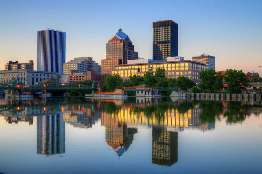 Rochester () is a city in the U.S. state of New York and the seat of Monroe County. It is the fourth-most populous city and 10th most-populated municipality in New York, with a population of 211,328 at the 2020 census. The city forms the core of the larger Rochester metropolitan area in Western New York, with a population of over 1.09 million residents. Throughout its history, Rochester has acquired several nicknames based on local industries; it has been known as "the Flour City" and "the Flower City" for its dual role in flour production and floriculture, and as the “Imaging Capital of the World" for its association with film and still photography.The city was one of the United States' first boomtowns, initially due to the fertile Genesee River valley which gave rise to numerous flour mills, and then as a manufacturing center, which spurred further rapid population growth. Rochester has also played a key part in US history as a hub for social and political movements, especially abolitionism, and the women's rights movement.Rochester is the birthplace and home of companies including Eastman Kodak, Xerox, Bausch & Lomb, Wegmans, Gannett, Paychex, and Western Union, and the region became a global center for science, technology, and research and development. This has been aided by the presence of several internationally renowned universities, notably the University of Rochester and Rochester Institute of Technology, and their research programs; these schools, along with many other smaller colleges, have played an increasingly large role in its economy. The city experienced significant population decline due to deindustrialization in the late 20th century, although less severely than its Rust Belt peers. The Rochester metropolitan area is the third-largest regional economy in New York, after New York City and Buffalo-Niagara Falls.Rochester is also known for its culture; in particular, the Eastman School of Music, one of the most prestigious conservatories in the world, and the Rochester International Jazz Festival anchor a vibrant music industry. It is the site of several museums such as The Strong National Museum of Play and the George Eastman Museum, which houses the oldest photography collection in the world. Rochester is a global city, ranked by the Globalization and World Cities Research Network as having sufficiency status.