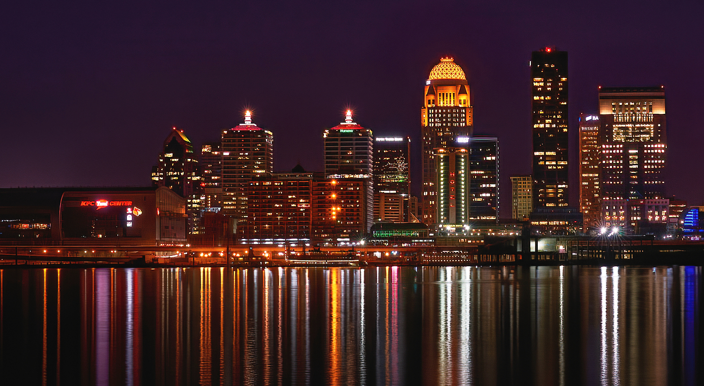 Louisville (varying pronunciations:   LOO-ee-vil, US:   LOO-ə-vəl, locally   LUUV-əl) is the most populous city in the Commonwealth of Kentucky, sixth-most populous city in the Southeast, and the 27th-most-populous city in the United States. By land area, it is the country's 24th-largest city, although by population density, it is the 265th most dense city. Louisville is the historical county seat and, since 2003, the nominal seat of Jefferson County, on the Indiana border.
Named after King Louis XVI of France, Louisville was founded in 1778 by George Rogers Clark, making it one of the oldest cities west of the Appalachians. With the nearby Falls of the Ohio as the only major obstruction to river traffic between the upper Ohio River and the Gulf of Mexico, the settlement first grew as a portage site. It was the founding city of the Louisville and Nashville Railroad, which grew into a 6,000-mile (9,700 km) system across 13 states.
Today, the city is known as the home of boxer Muhammad Ali, the Kentucky Derby, Kentucky Fried Chicken, the University of Louisville and its Cardinals, Louisville Slugger baseball bats, and three of Kentucky's six Fortune 500 companies: Humana, Kindred Healthcare, and Yum! Brands. Muhammad Ali International Airport, Louisville's main commercial airport, hosts UPS's worldwide hub.
Since 2003, Louisville's borders have been the same as those of Jefferson County, after a city-county merger. The official name of this consolidated city-county government is the Louisville/Jefferson County Metro Government, abbreviated to Louisville Metro. Despite the merger and renaming, the term "Jefferson County" continues to be used in some contexts in reference to Louisville Metro, particularly including the incorporated cities outside the "balance" which make up Louisville proper. The city's total consolidated population as of the 2020 census was 782,969. However, the balance total of 633,045 excludes other incorporated places and semiautonomous towns within the county and is the population listed in most sources and national rankings.
The Louisville-Jefferson County, KY-IN Metropolitan Statistical Area (MSA) includes Louisville-Jefferson County and 12 surrounding counties, seven in Kentucky and five in Southern Indiana. As of 2019, the MSA had a population of 1,395,634, the 43rd largest in the nation.