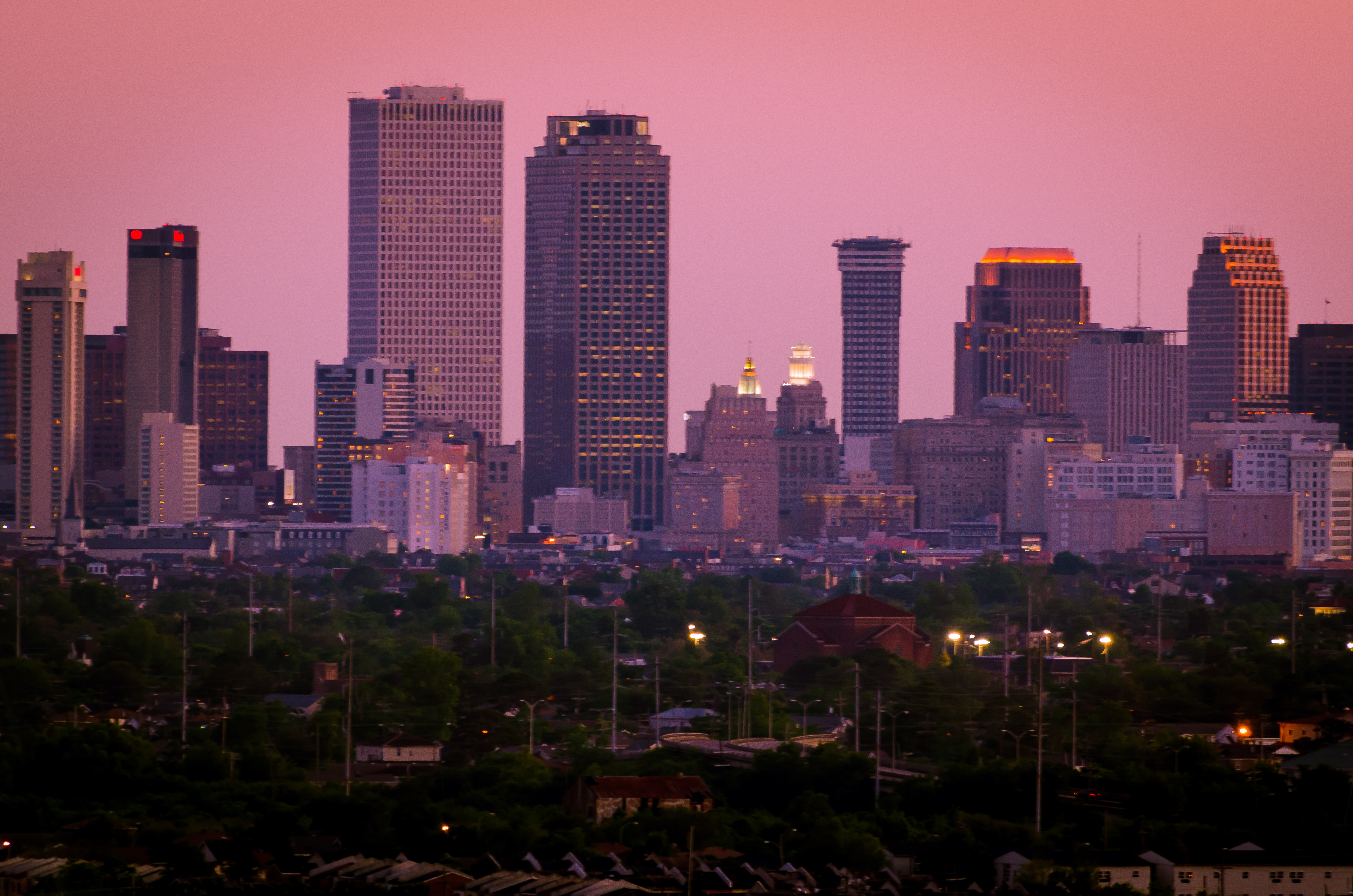 New Orleans ( OR-l(ee)ənz,  or-LEENZ, locally  OR-lənz; French: La Nouvelle-Orléans [la nuvɛlɔʁleɑ̃] ) is a consolidated city-parish located along the Mississippi River in the southeastern region of the U.S. state of Louisiana. With a population of 383,997 according to the 2020 U.S. census, it is the most populous city in Louisiana and the French Louisiana region; third most populous city in the Deep South; and the twelfth-most populous city in the southeastern United States. Serving as a major port, New Orleans is considered an economic and commercial hub for the broader Gulf Coast region of the United States.
New Orleans is world-renowned for its distinctive music, Creole cuisine, unique dialects, and its annual celebrations and festivals, most notably Mardi Gras. The historic heart of the city is the French Quarter, known for its French and Spanish Creole architecture and vibrant nightlife along Bourbon Street. The city has been described as the "most unique" in the United States, owing in large part to its cross-cultural and multilingual heritage. Additionally, New Orleans has increasingly been known as "Hollywood South" due to its prominent role in the film industry and in pop culture.Founded in 1718 by French colonists, New Orleans was once the territorial capital of French Louisiana before becoming part of the United States in the Louisiana Purchase of 1803. New Orleans in 1840 was the third most populous city in the United States, and it was the largest city in the American South from the Antebellum era until after World War II. The city has historically been very vulnerable to flooding, due to its high rainfall, low lying elevation, poor natural drainage, and proximity to multiple bodies of water. State and federal authorities have installed a complex system of levees and drainage pumps in an effort to protect the city.New Orleans was severely affected by Hurricane Katrina in August 2005, which flooded more than 80% of the city, killed more than 1,800 people, and displaced thousands of residents, causing a population decline of over 50%. Since Katrina, major redevelopment efforts have led to a rebound in the city's population. Concerns have been expressed about gentrification, new residents buying property in formerly closely knit communities, and displacement of longtime residents. Additionally, high rates of violent crime continue to plague the city with New Orleans experiencing 280 murders in 2022, resulting in the highest per capita homicide rate in the United States.The city and Orleans Parish (French: paroisse d'Orléans) are coterminous. As of 2017, Orleans Parish is the third most populous parish in Louisiana, behind East Baton Rouge Parish and neighboring Jefferson Parish. The city and parish are bounded by St. Tammany Parish and Lake Pontchartrain to the north, St. Bernard Parish and Lake Borgne to the east, Plaquemines Parish to the south, and Jefferson Parish to the south and west.
The city anchors the larger Greater New Orleans metropolitan area, which had a population of 1,271,845 in 2020. Greater New Orleans is the most populous metropolitan statistical area (MSA) in Louisiana and, since the 2020 census, has been the 46th most populous MSA in the United States.

