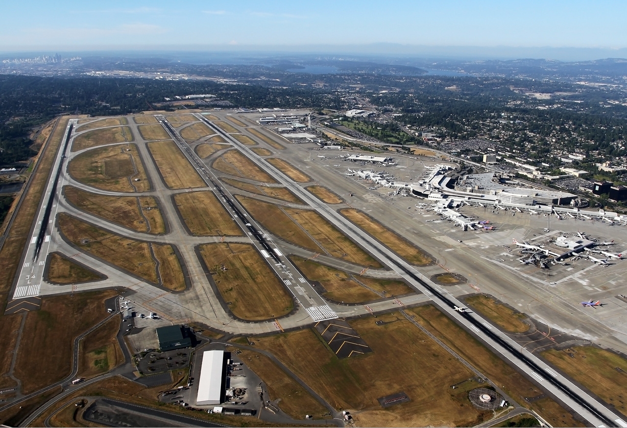 Seattle–Tacoma International Airport (IATA: SEA, ICAO: KSEA, FAA LID: SEA), branded as SEA Airport and also referred to as Sea–Tac (), is the primary commercial airport serving the Seattle metropolitan area in the U.S. state of Washington. It is in the city of SeaTac, which was named after the airport's nickname “Sea-Tac”, approximately 14 miles (23 km) south of Downtown Seattle and 18 miles (29 km) north-northeast of Downtown Tacoma. The airport is the busiest in the Pacific Northwest region of North America and is owned by Port of Seattle.
The entire airport covers an area of 2,500 acres (3.9 sq mi; 10 km2). The airport has flights to cities throughout North America, Oceania, Europe, the Middle East, and Asia. It is the primary hub for Alaska Airlines, whose headquarters are near the airport. It is also a hub and international gateway for Delta Air Lines, which has expanded at the airport since 2011. As of 2022, 31 airlines operate at SEA, serving 91 domestic and 28 international destinations.