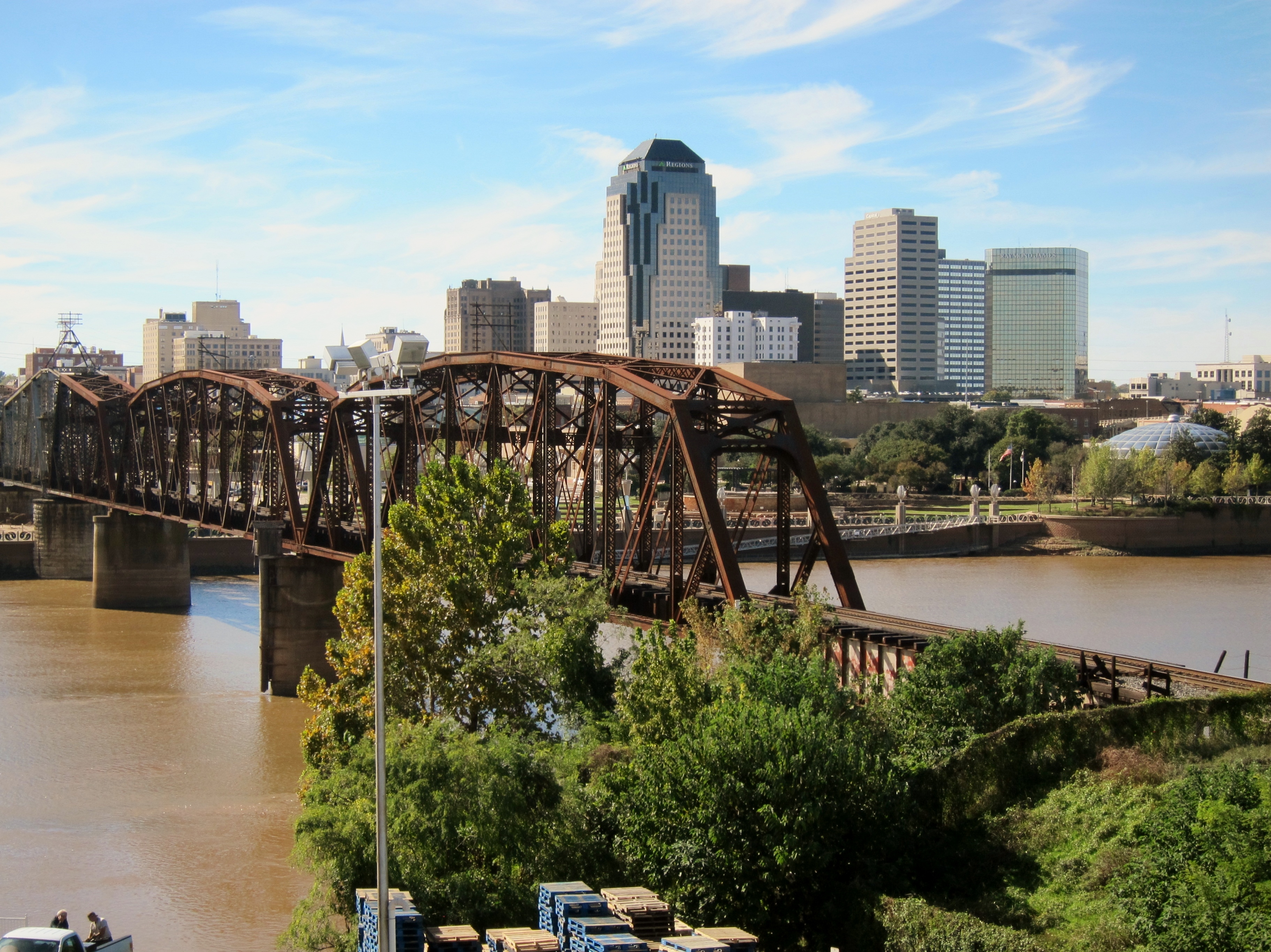 Shreveport ( SHREEV-port) is a city in the U.S. state of Louisiana. It is the third-most populous city  in Louisiana after New Orleans and Baton Rouge. The bulk of Shreveport is in Caddo Parish, of which it is the parish seat. It extends along the west bank of the Red River into neighboring Bossier Parish. The 2020 census tabulation for the city's population was 187,593, while the Shreveport–Bossier City metropolitan area had a population of 393,406.Shreveport was founded in 1836 by the Shreve Town Company, a corporation established to develop a town at the juncture of the newly navigable Red River and the Texas Trail, an overland route into the newly independent Republic of Texas. It grew throughout the 20th century and, after the discovery of oil in Louisiana, became a national center for the oil industry. Standard Oil of Louisiana and United Gas Corporation were headquartered in the city until the 1960s and 1980s, respectively. After the loss of jobs in the oil industry, the closure of General Motors' Shreveport Operations, and other economic problems, it struggled with a declining population, poverty, drugs, and violent crime. However, the city continues in its efforts to revitalize its infrastructure, revive the economy through diversification, and lower crime. Despite these efforts, the city witnessed the largest number of homicides in its recorded history in 2021, eclipsing the previous record set in 1993.Shreveport is the educational, commercial and cultural center of the Ark-La-Tex region, where Arkansas, Louisiana, and Texas meet. It is the location of Centenary College of Louisiana, Louisiana State University Shreveport, Louisiana Tech University Shreveport, Southern University at Shreveport, and Louisiana Baptist University. It forms part of the I-20 Cyber Corridor linking Shreveport to Dallas and Atlanta. Companies with significant operations or headquarters in Shreveport are Amazon, Regions Financial Corporation, JPMorgan Chase, Sam's Town Hotel and Gambling Hall, AT&T Mobility, United Parcel Service, Walmart, SWEPCO, General Electric, UOP LLC, Calumet Specialty Products Partners, and APS Payroll.